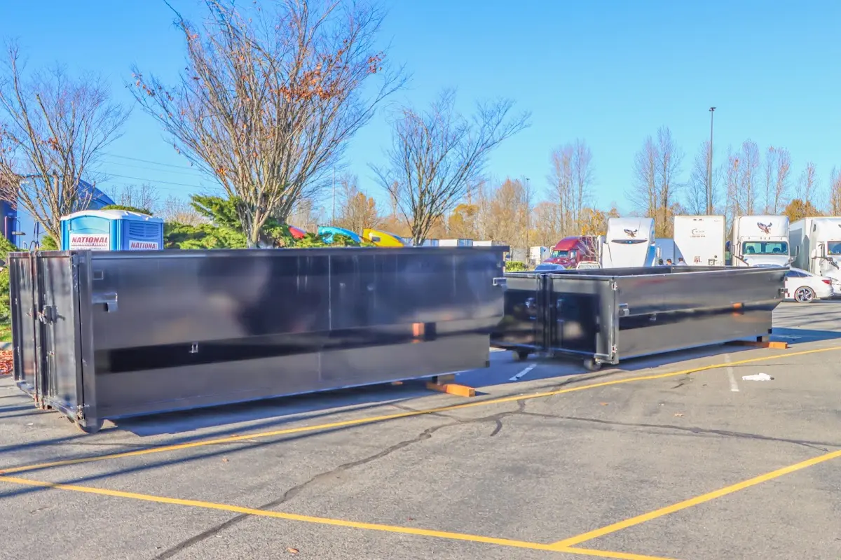 Professional dumpster rental service with roll-off container on residential driveway in Steamboat Springs